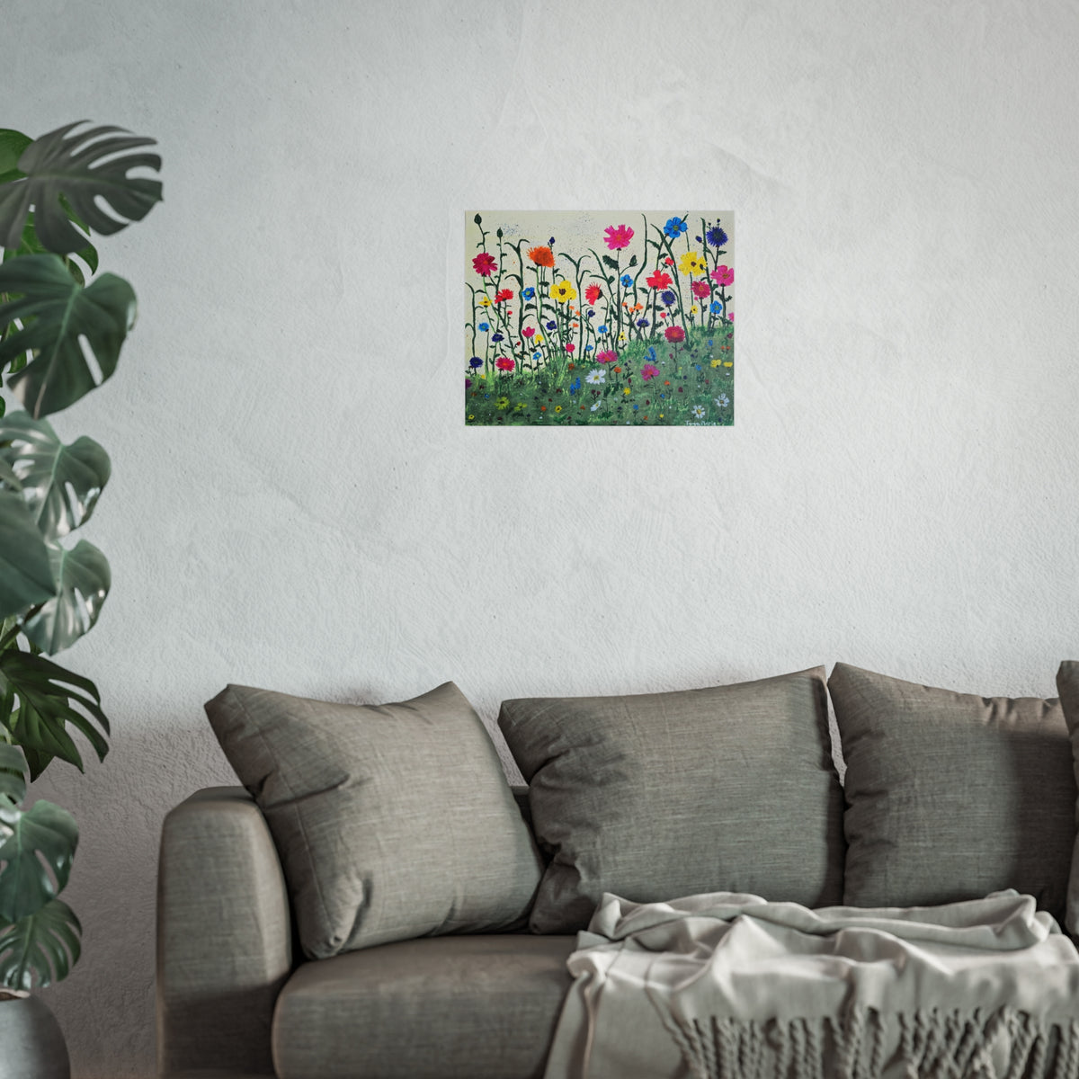 Matte wildflower art poster on wall above gray sofa with cushions and blanket
