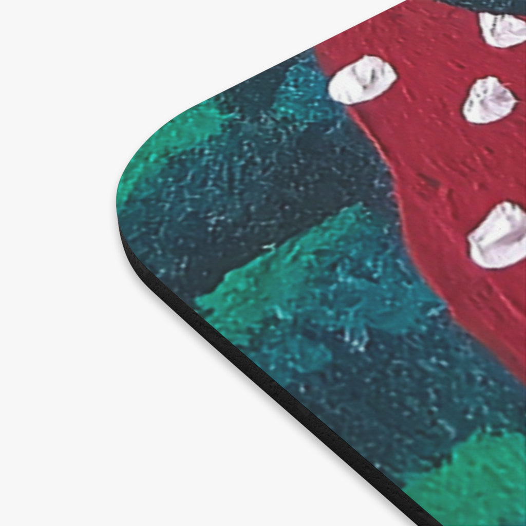 Rounded rectangle mouse pad corner showing printed mushroom pattern in red and teal tones