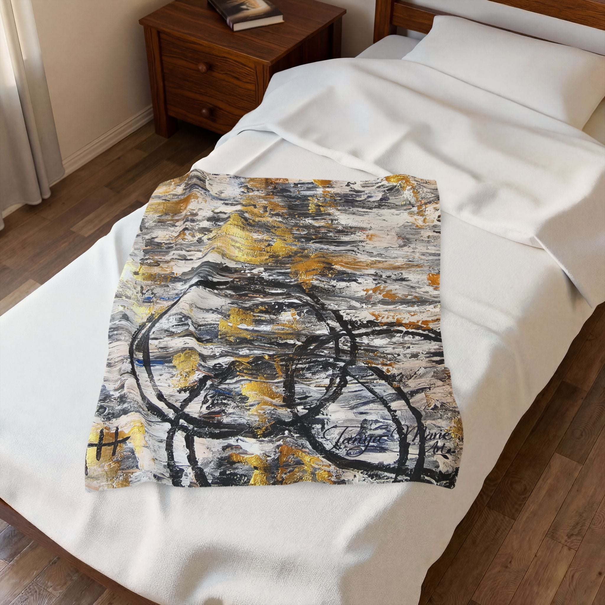 Velveteen plush blanket with black-and-gold abstract circles on white background