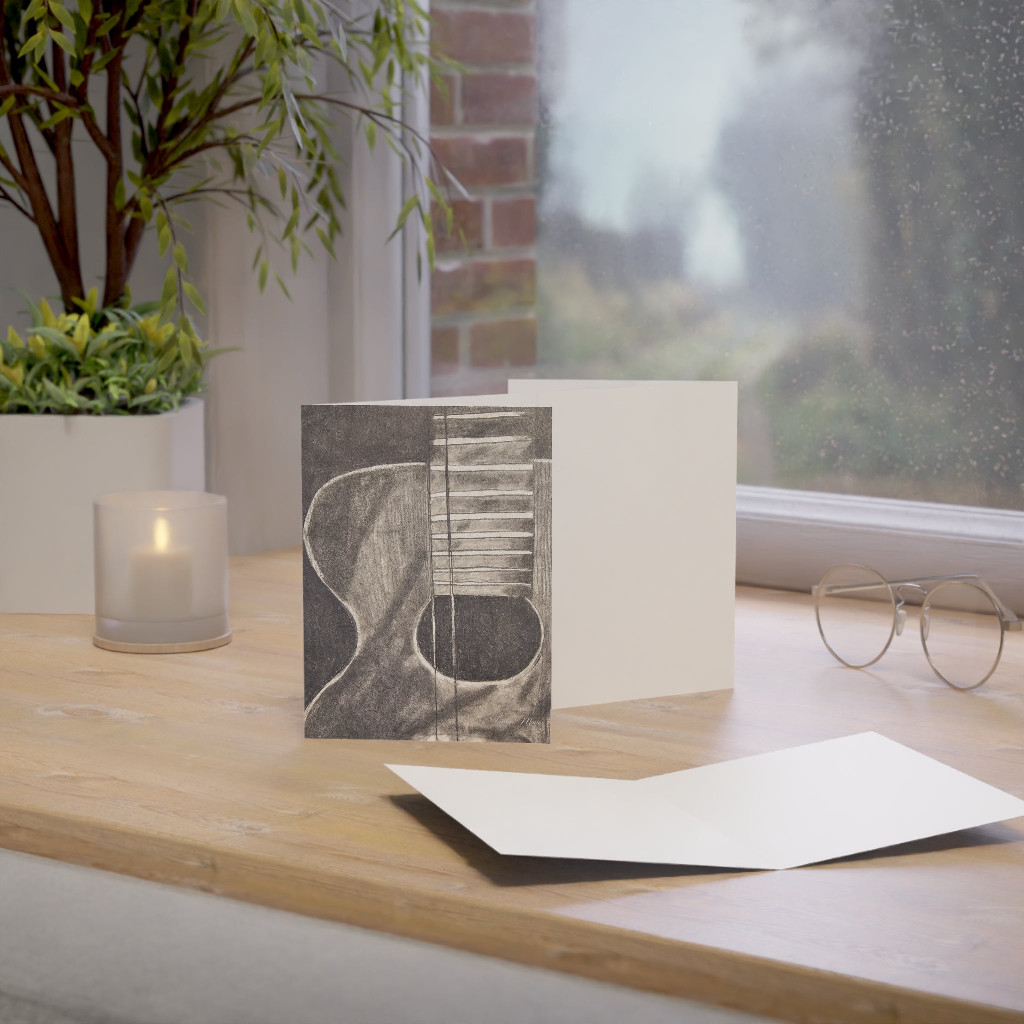 Acoustic guitar sketch greeting card with guitar illustration on cover, plus blank white card insert.