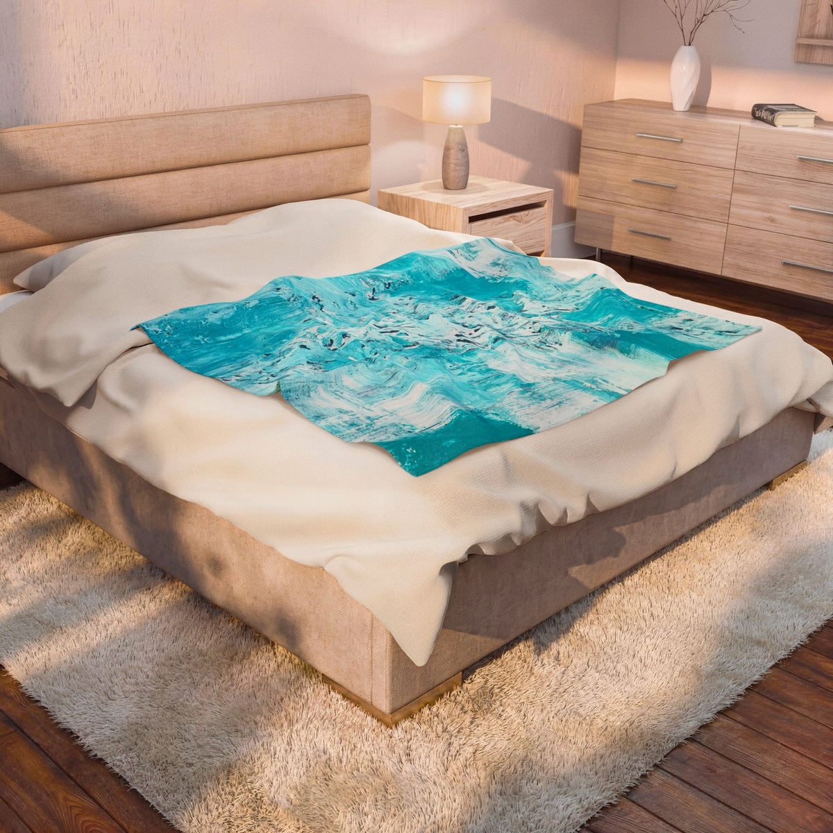 Velveteen plush blanket with turquoise abstract ocean swirl design on light fabric