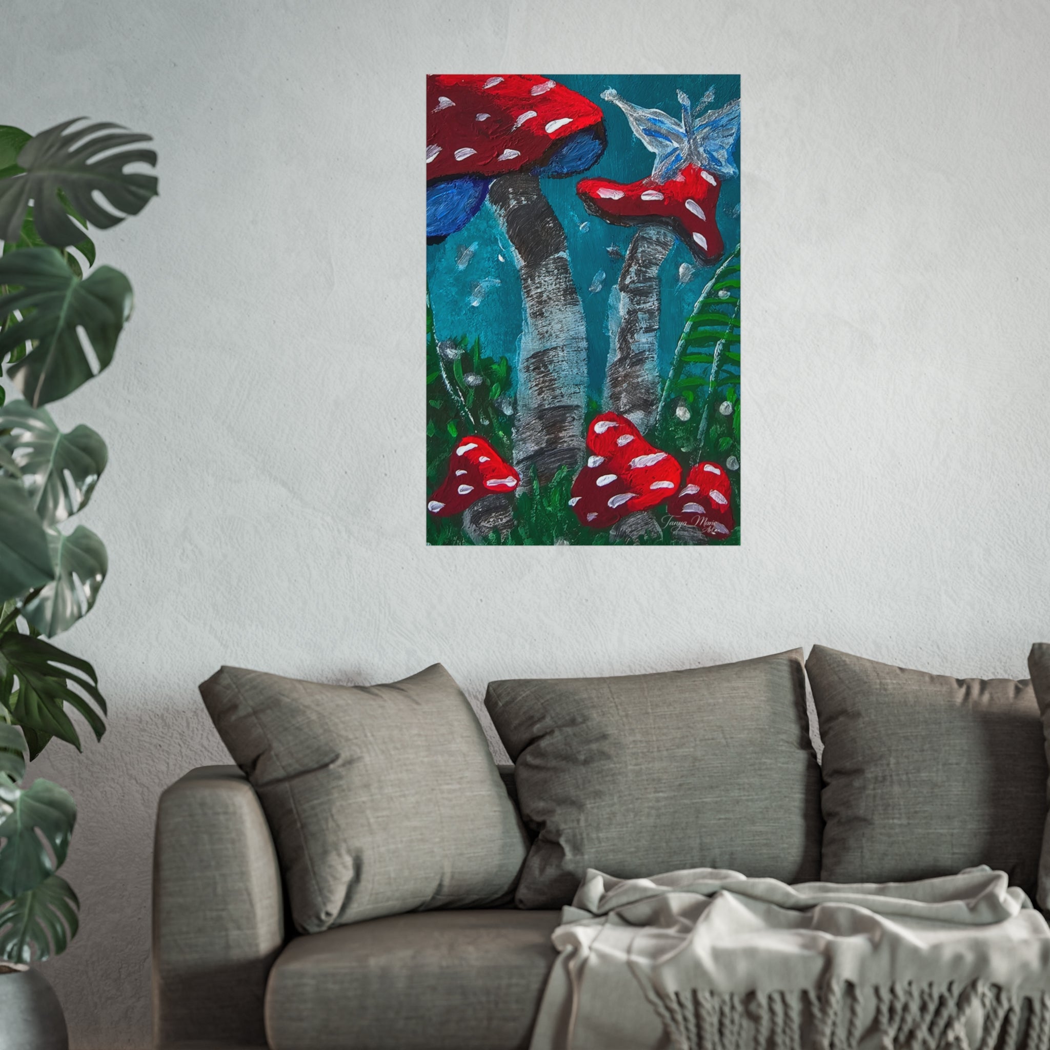 Wall poster of red toadstools with blue-green stems displayed above a gray sofa