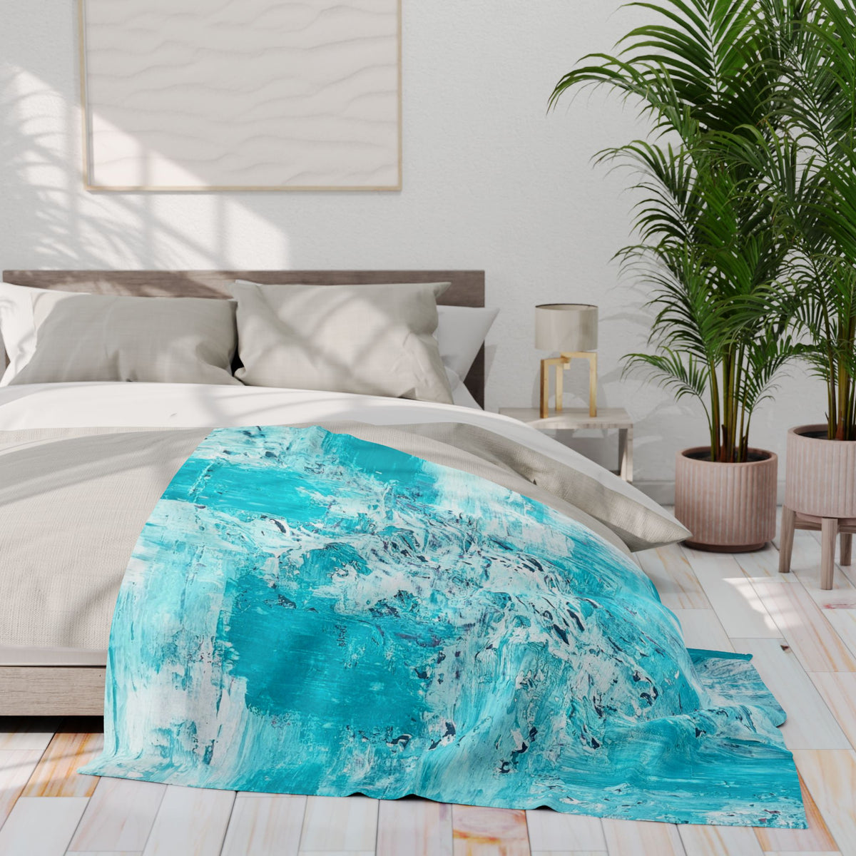 Turquoise abstract fleece blanket draped over a bed, soft textured surface.