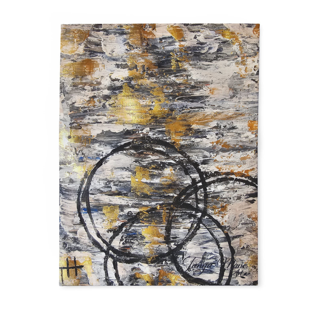 Abstract fleece blanket with grey and gold brush textures and bold black circle design
