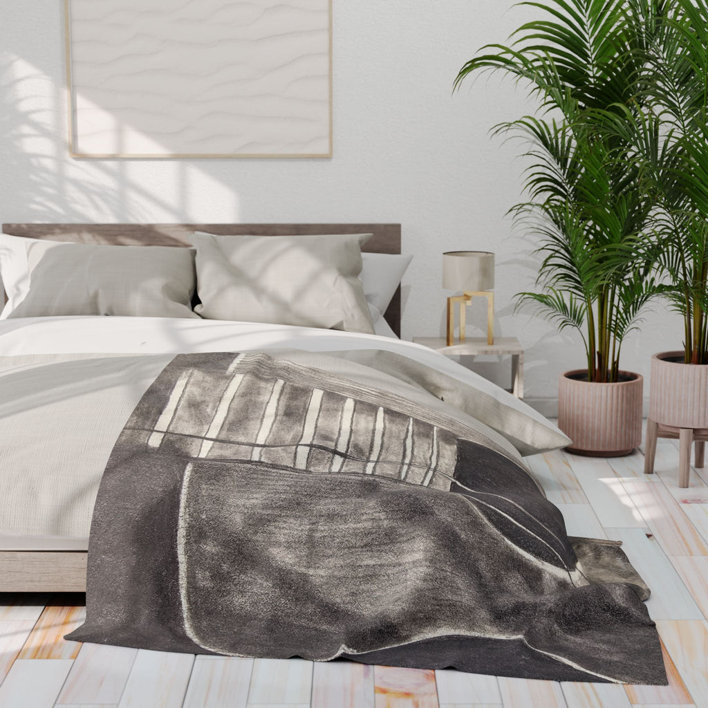 Gray fleece blanket on bed, featuring acoustic guitar line art