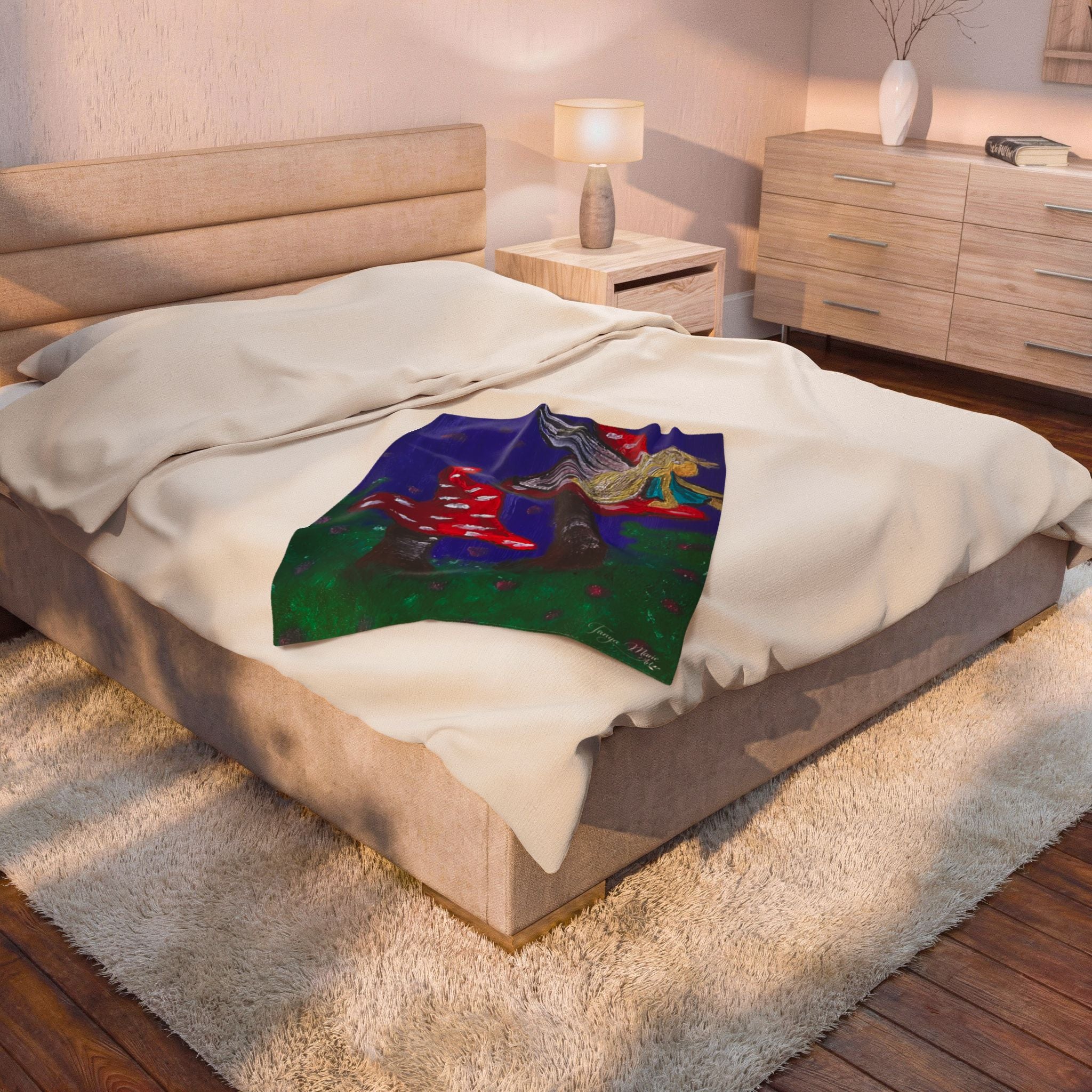 Plush velveteen blanket draped on bed with fairy and red toadstool artwork