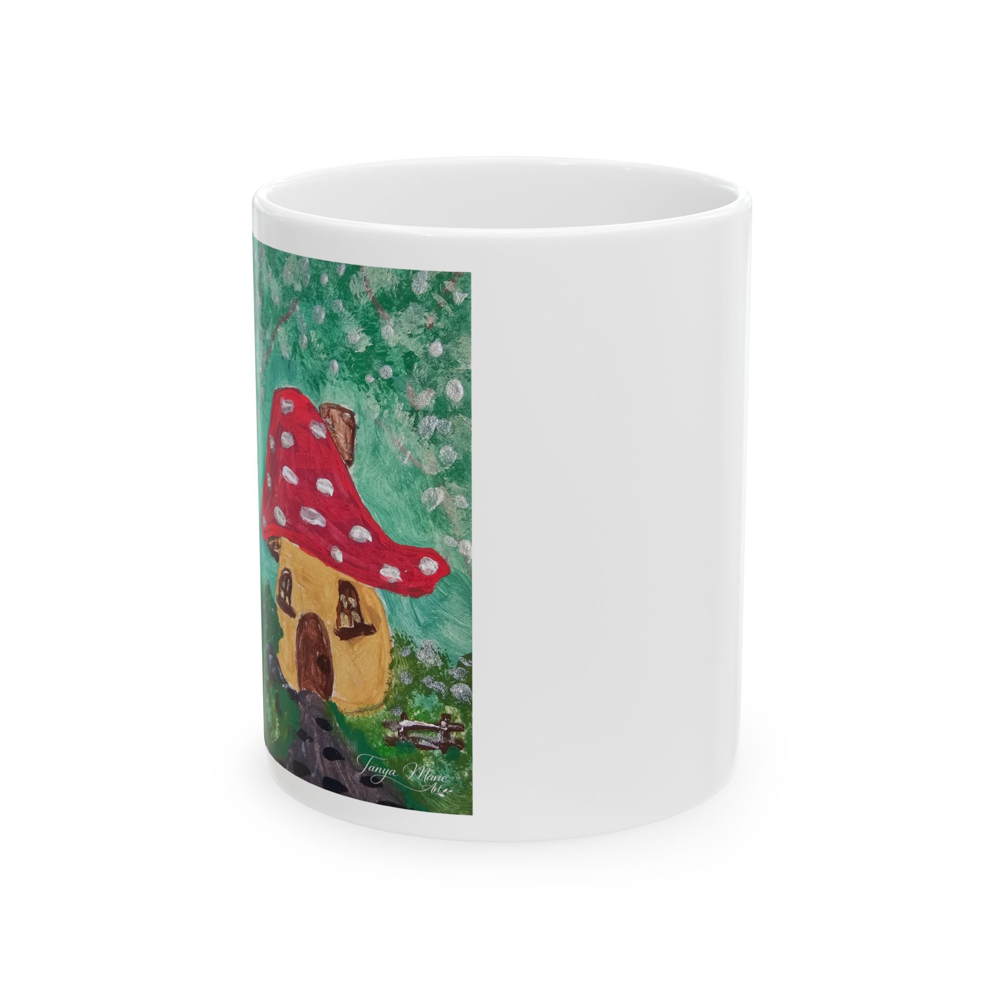 White ceramic coffee mug with side graphic of red mushroom cottage illustration