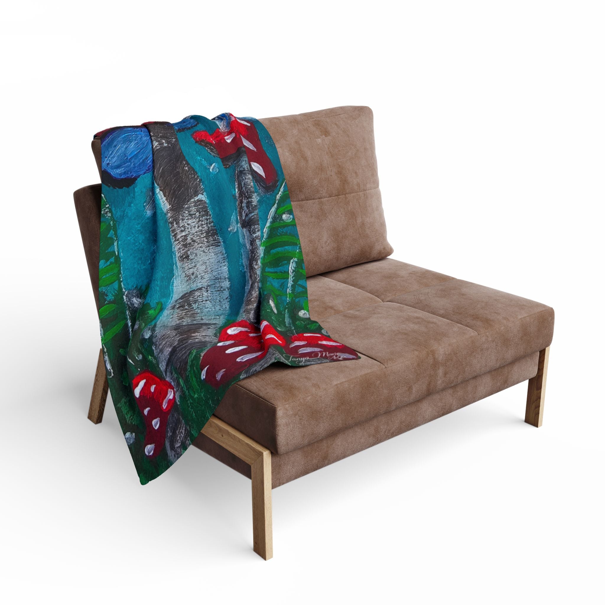 Fleece blanket draped over a bench-style seat, showing red mushrooms and teal forest print