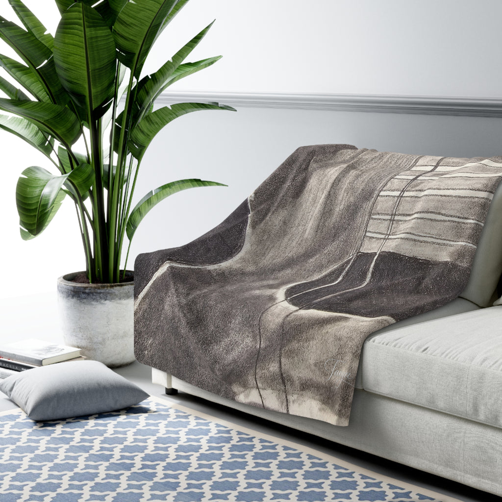 Sherpa-style blanket draped on sofa, featuring centered gray acoustic guitar print