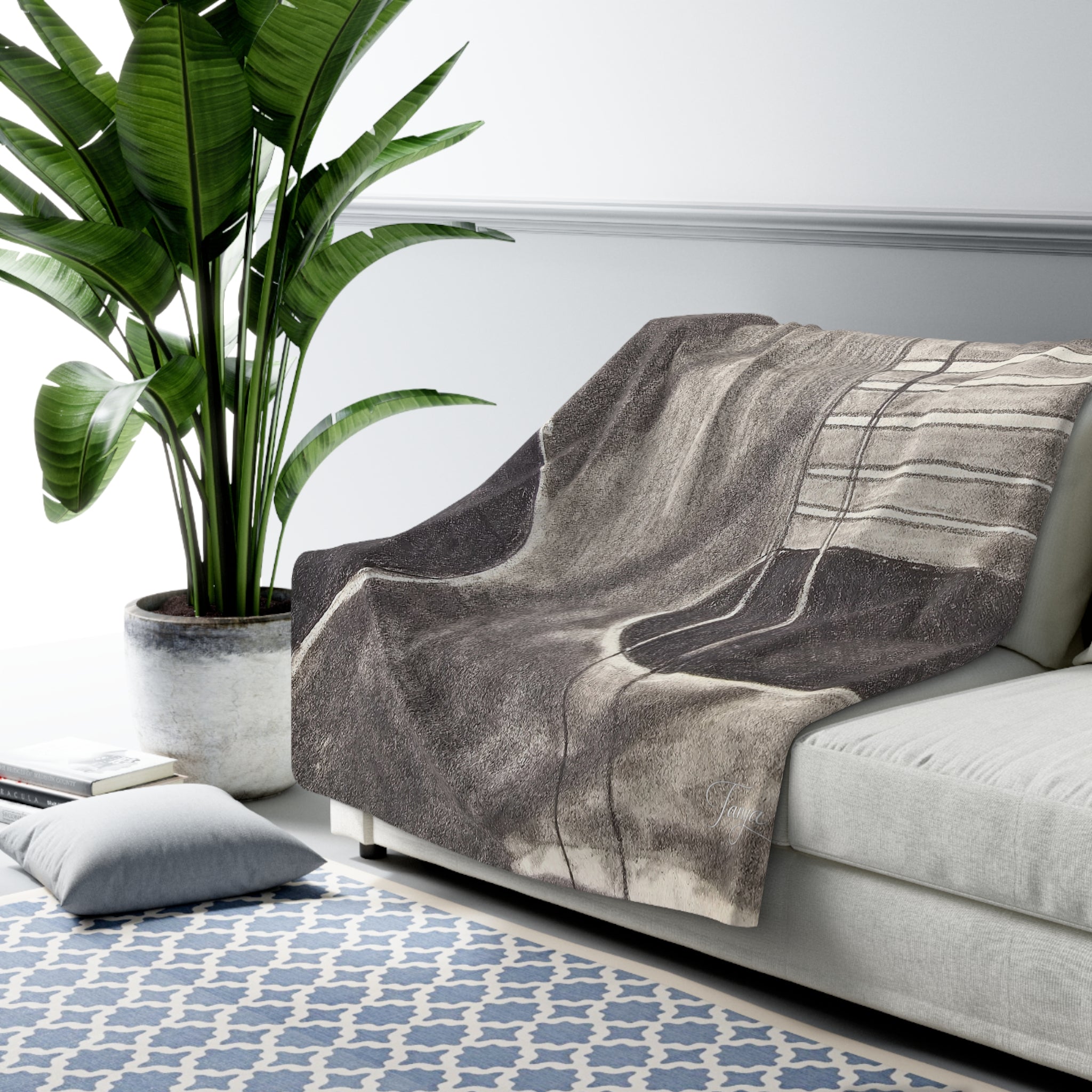 Sherpa-style blanket draped on sofa, featuring centered gray acoustic guitar print