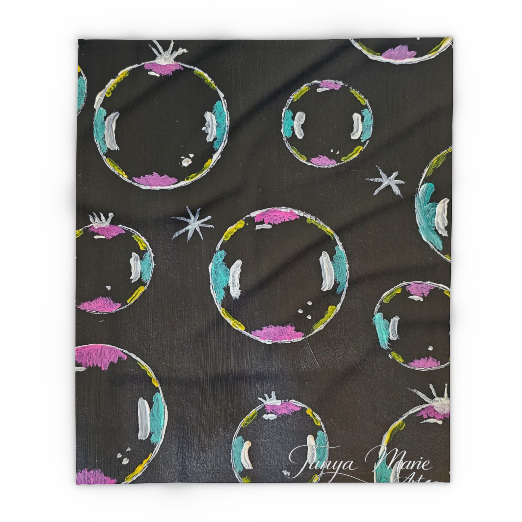Fleece throw blanket, dark fabric with colorful circular bubbles and small star accents