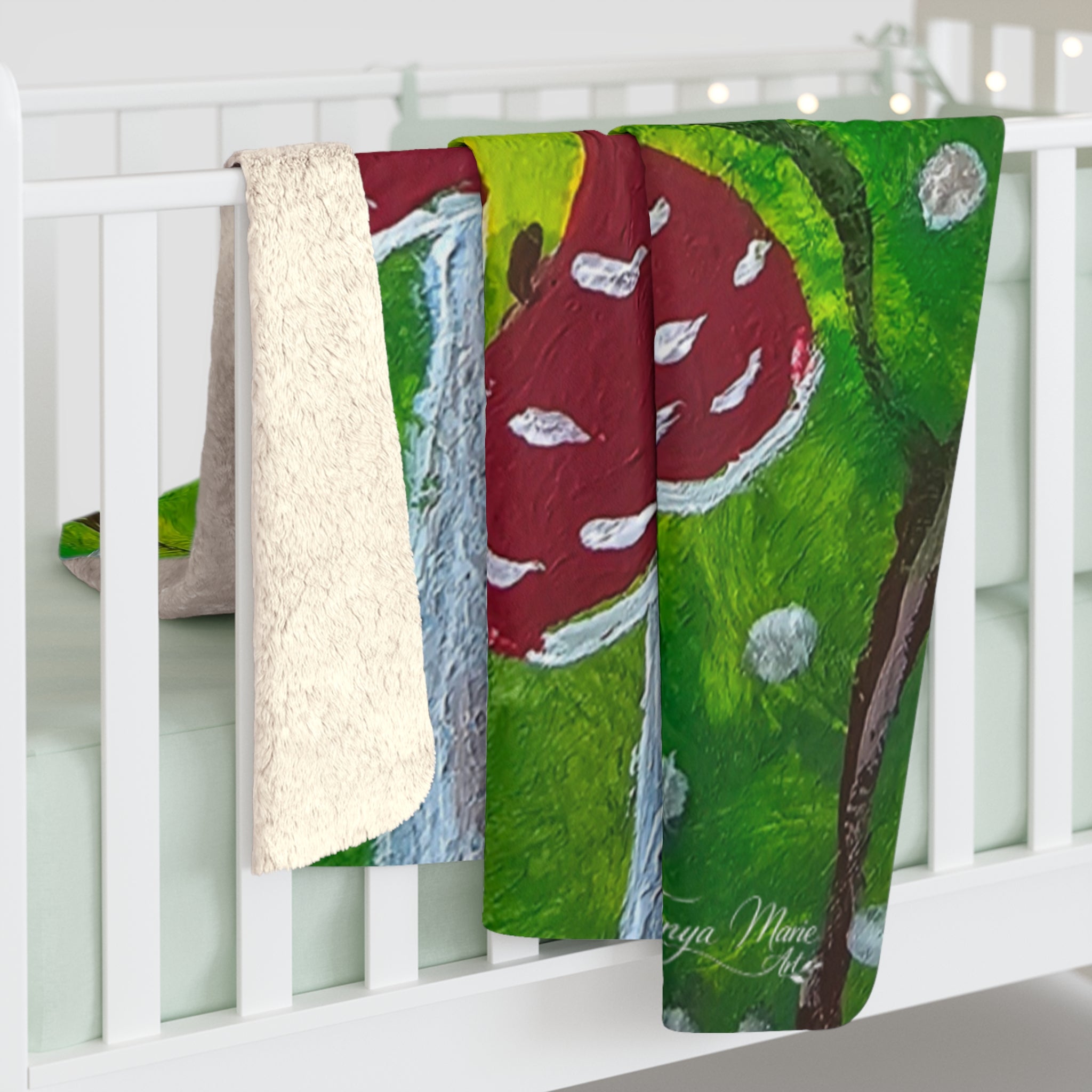 Sherpa blanket draped over crib rail, off-white sherpa edge with green and red mushroom print