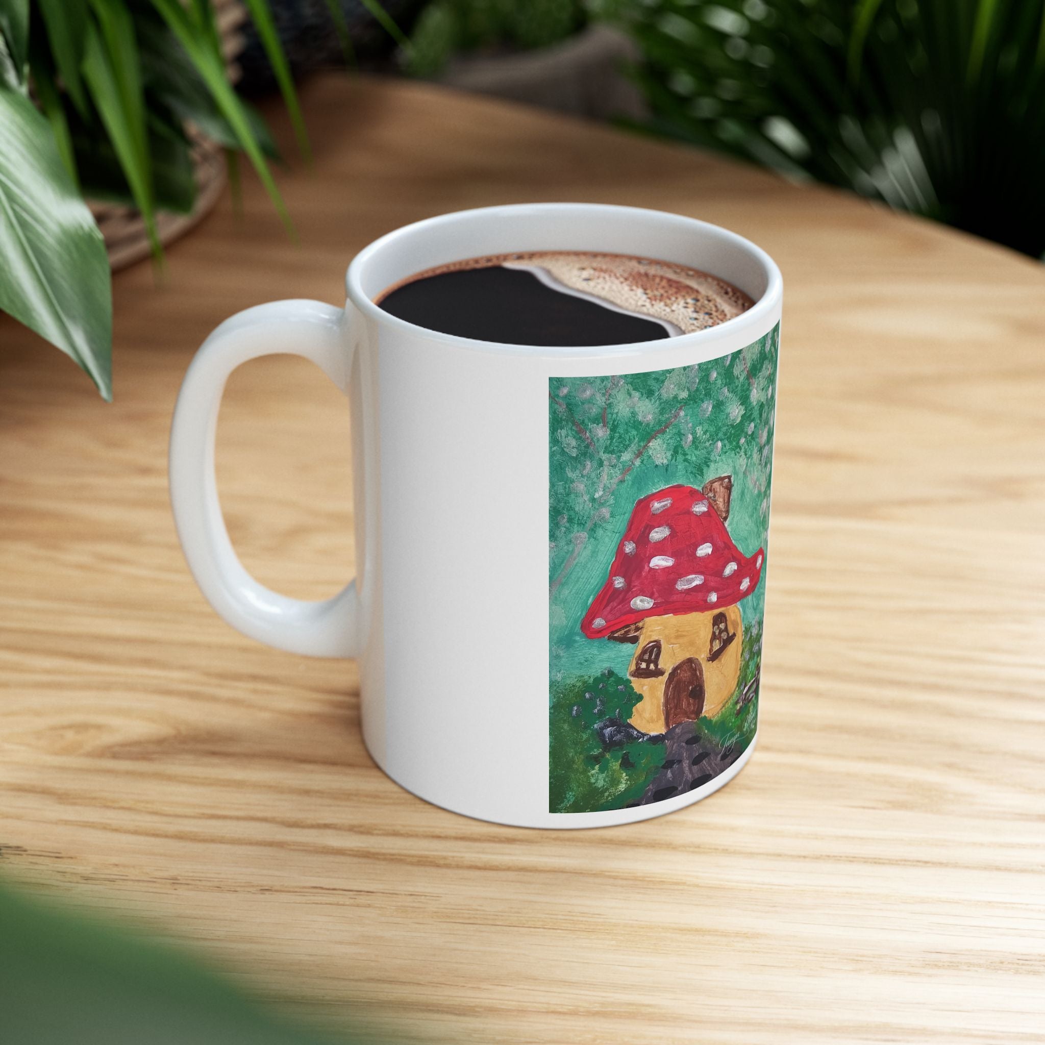 White ceramic coffee mug with red mushroom cottage print, filled with coffee