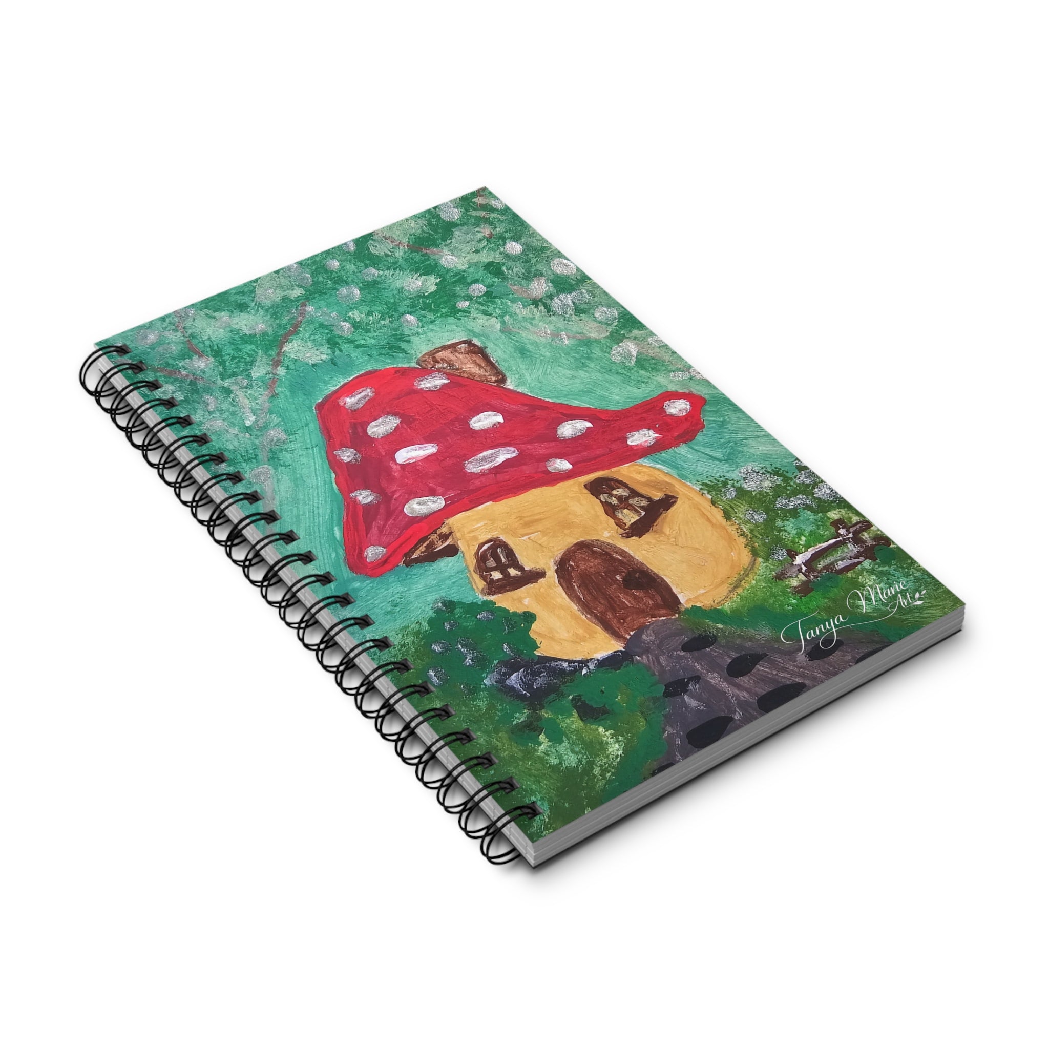 Spiral journal notebook with mushroom cottage cover, angled view with black binding.