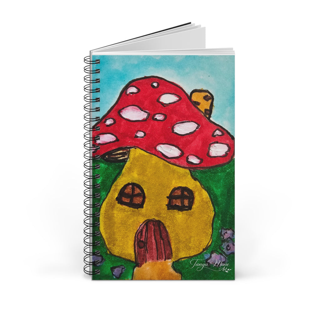 Spiral notebook with mushroom cottage cover art, with pages slightly visible behind.