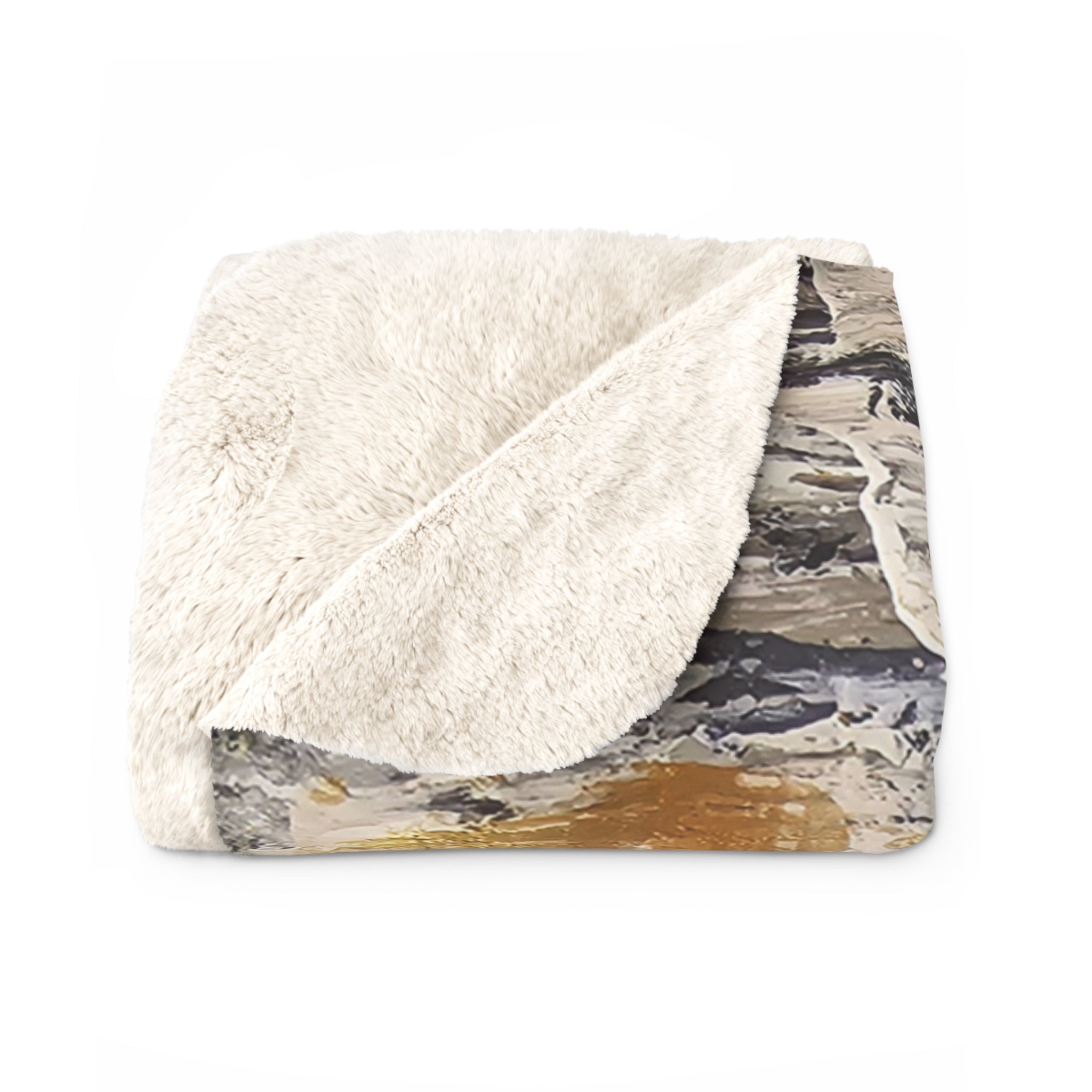 Cream sherpa fleece blanket with folded edge revealing abstract gold and charcoal backing