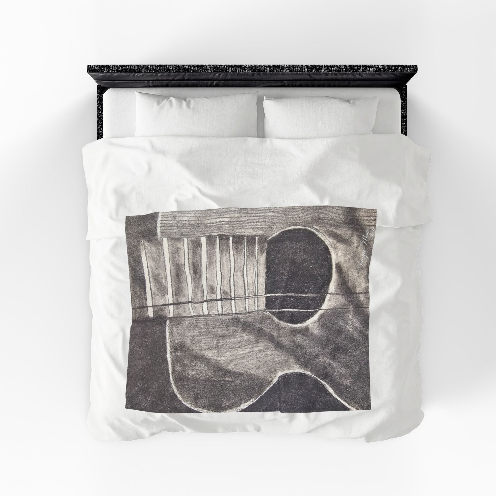 Velveteen plush blanket on bed, centered gray guitar sketch with white-lined strings