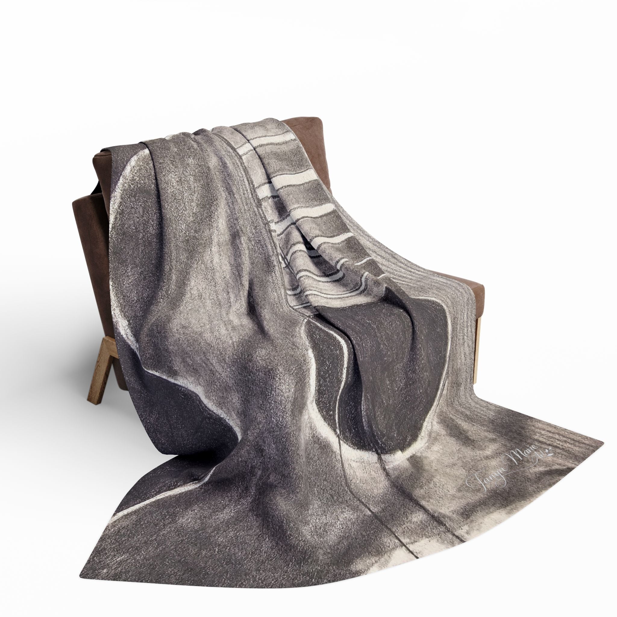 Gray fleece blanket with acoustic guitar sketch, folded over chair back