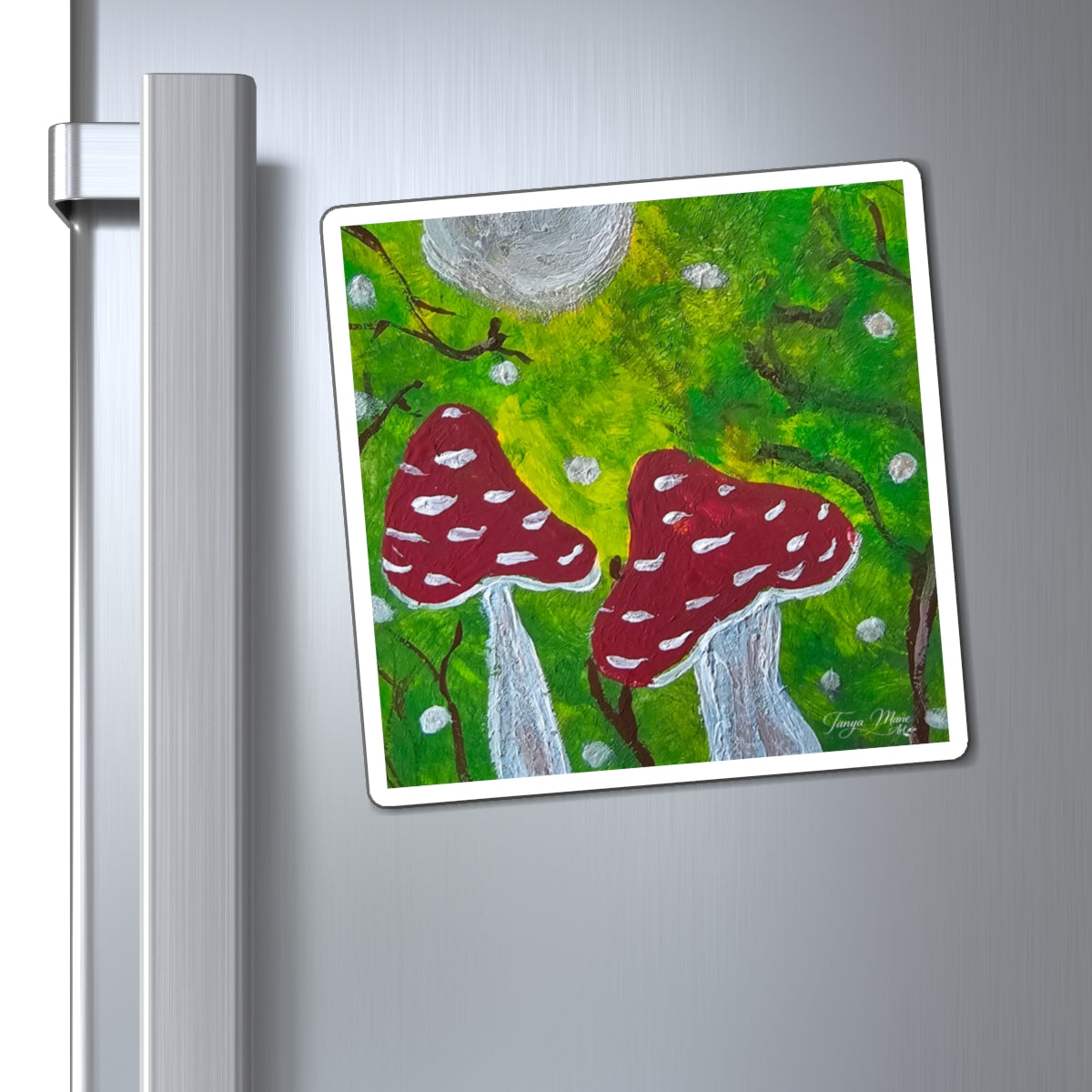 Hand-painted toadstool magnet on a fridge with red mushrooms, white spots, and gray moon