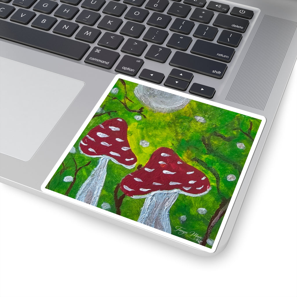 Kiss-cut sticker on laptop corner, red toadstools and gray waterfall in green forest.
